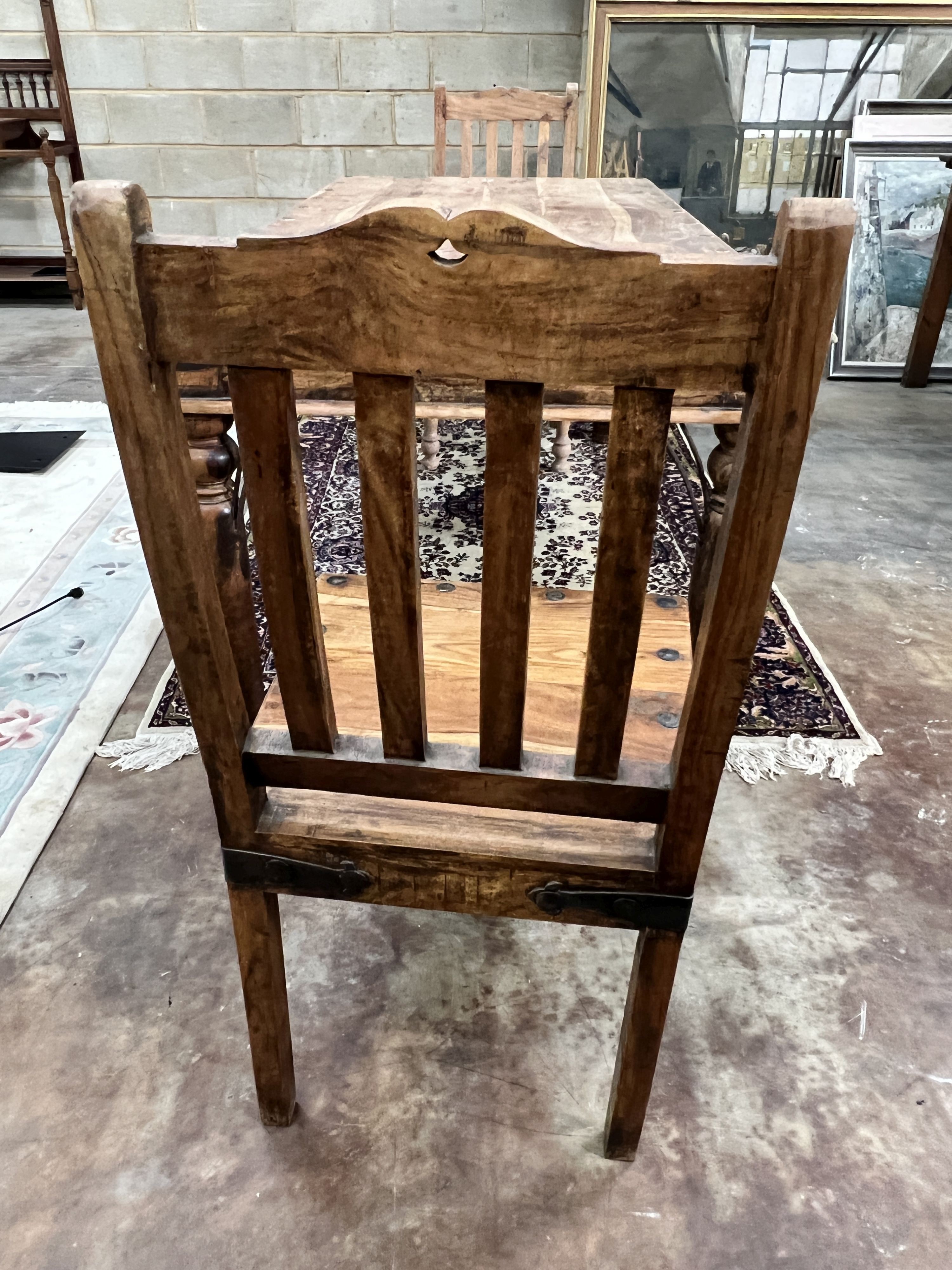 An Indonesian rectangular studded hardwood dining table, length 180cm, depth 90cm, height 76cm and two chairs